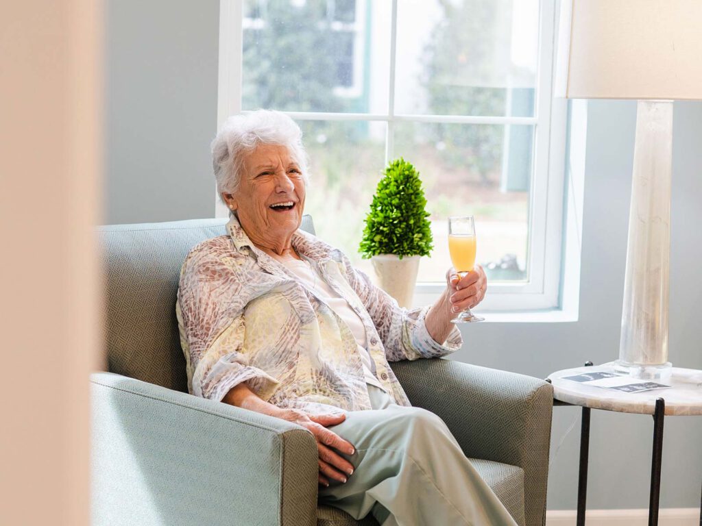 Senior woman seated holding a cocktail