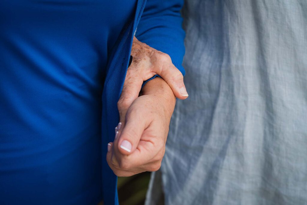 Close up view of two women holding hands