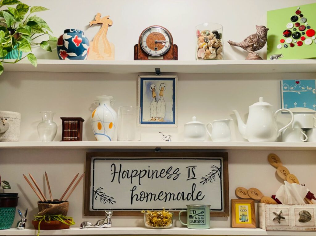 View of shelving unit with several knickknacks on each shelf 