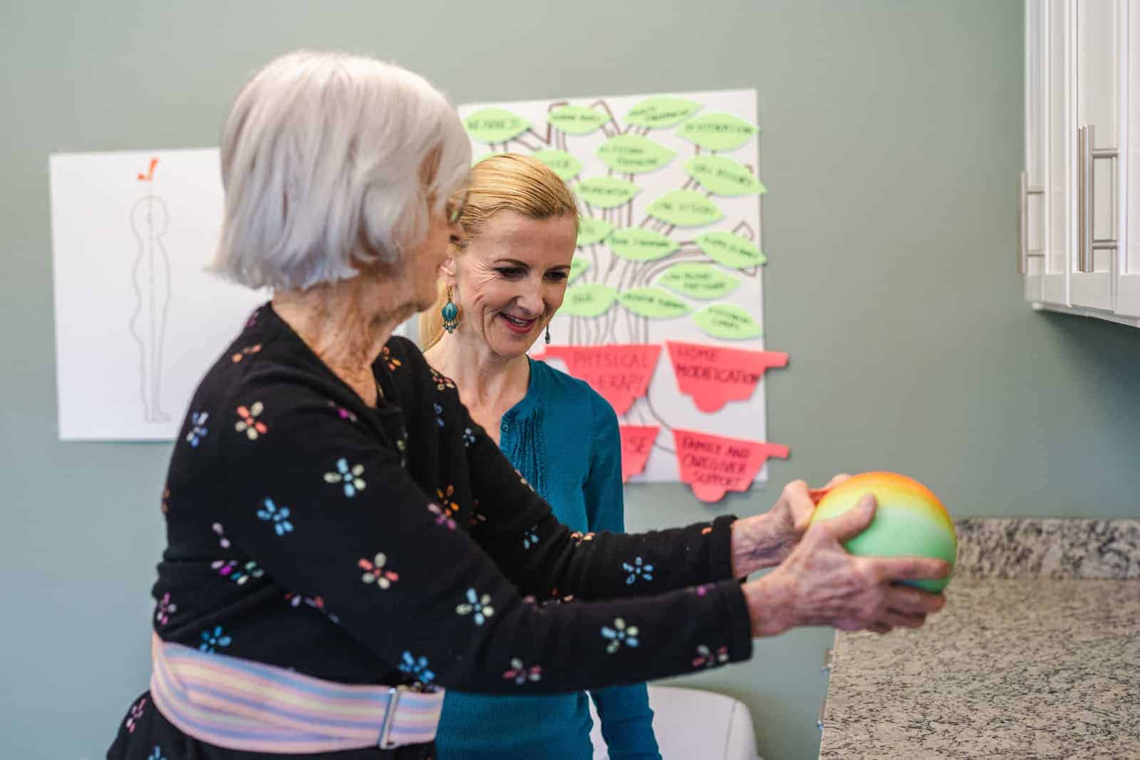 Senior woman and staff member during a physical therapy exercise